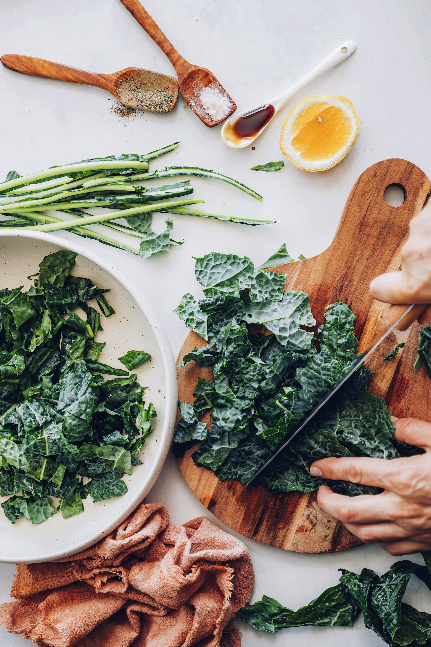 Slicing kale on a cutting board