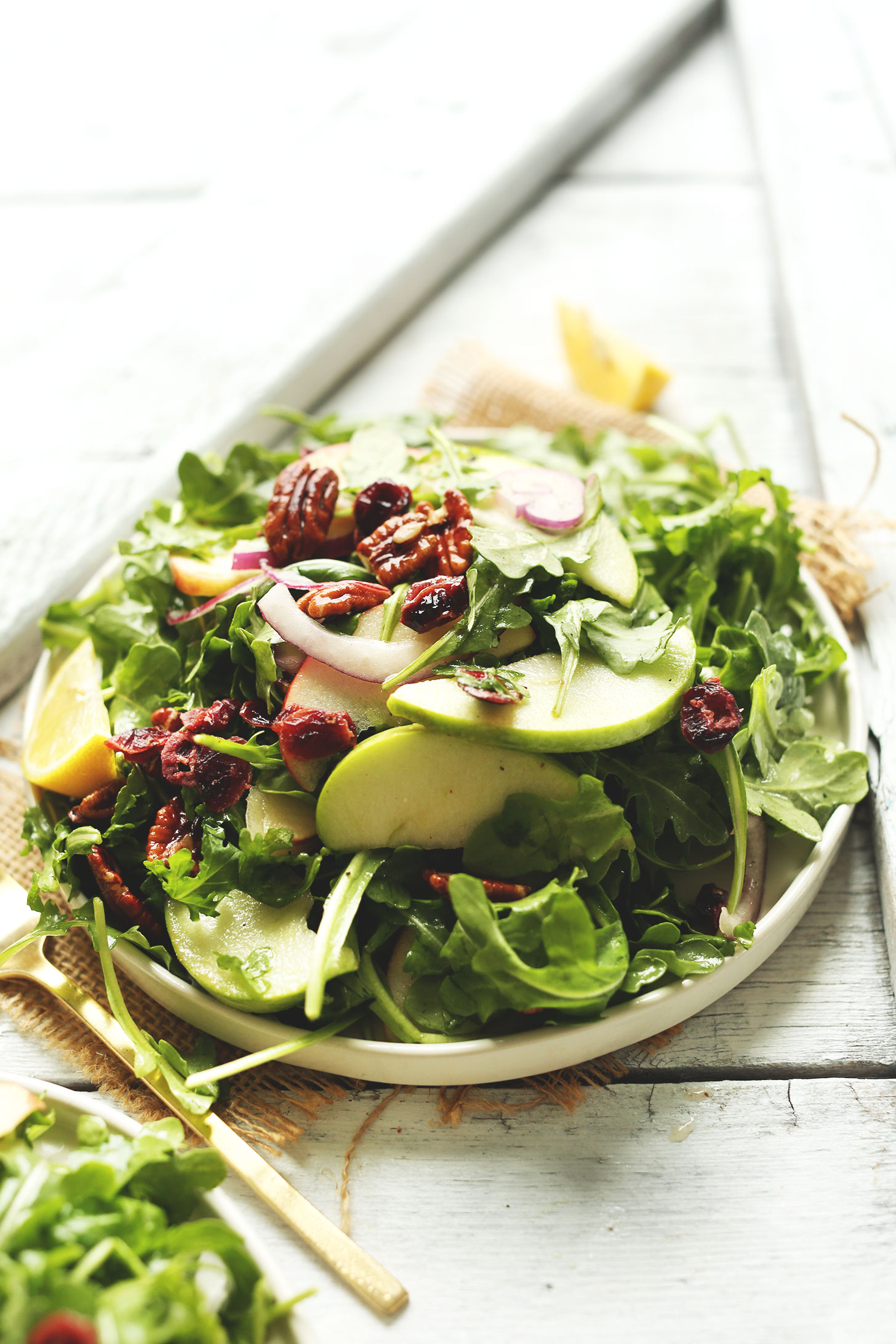 Plate of our Apple Arugula Salad with Pecans and Lemon Vinaigrette for a hearty fall side dish