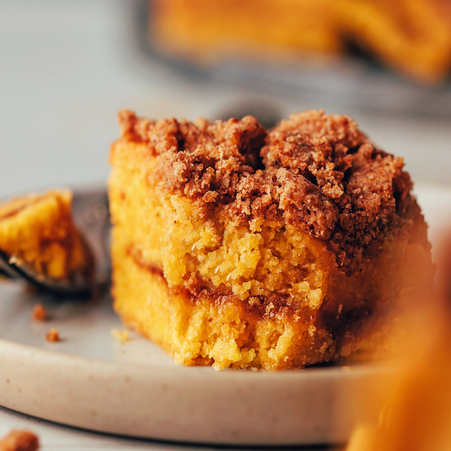 Partially eaten slice of pumpkin coffee cake on a plate