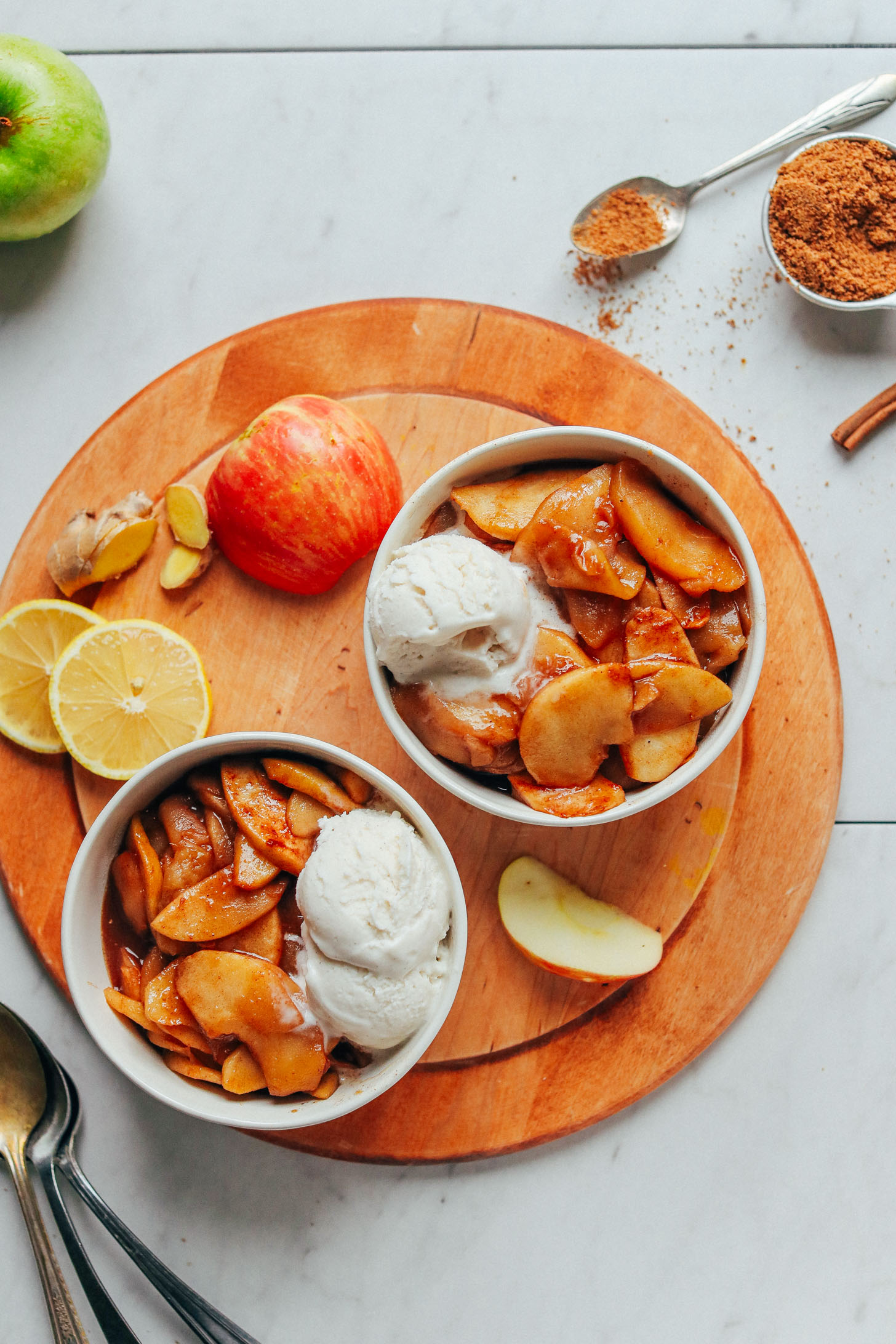 Two serving bowls with Cinnamon Baked Apples and vegan ice cream