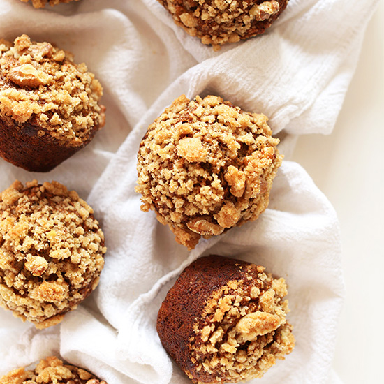 Batch of Vegan Banana Crumble Top Muffins on a white linen