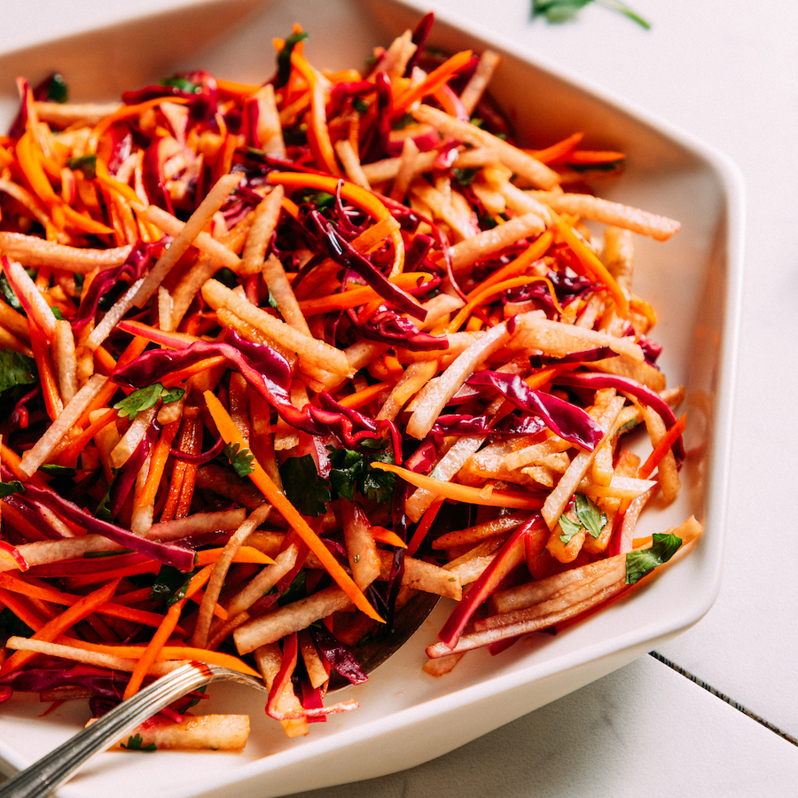 Fork resting on a plate of jicama slaw