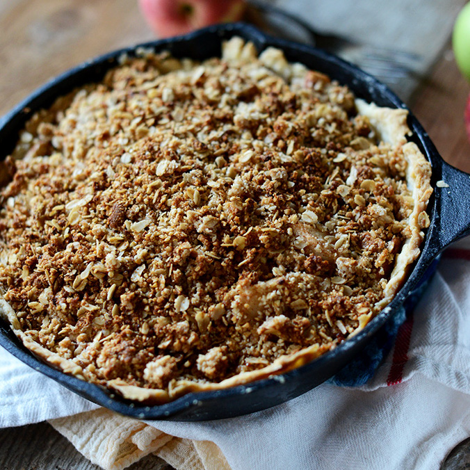 Overhead shot of a cast iron skillet filled with apple pie