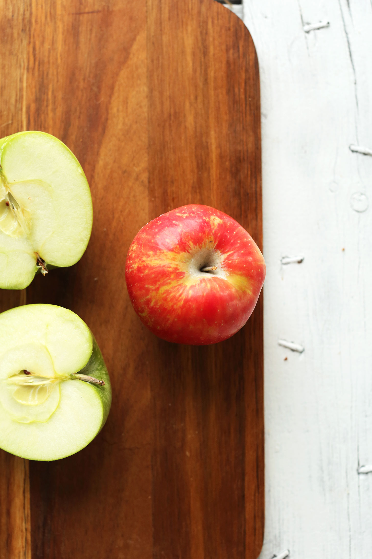 Cutting board with apples for making a healthy fall salad recipe