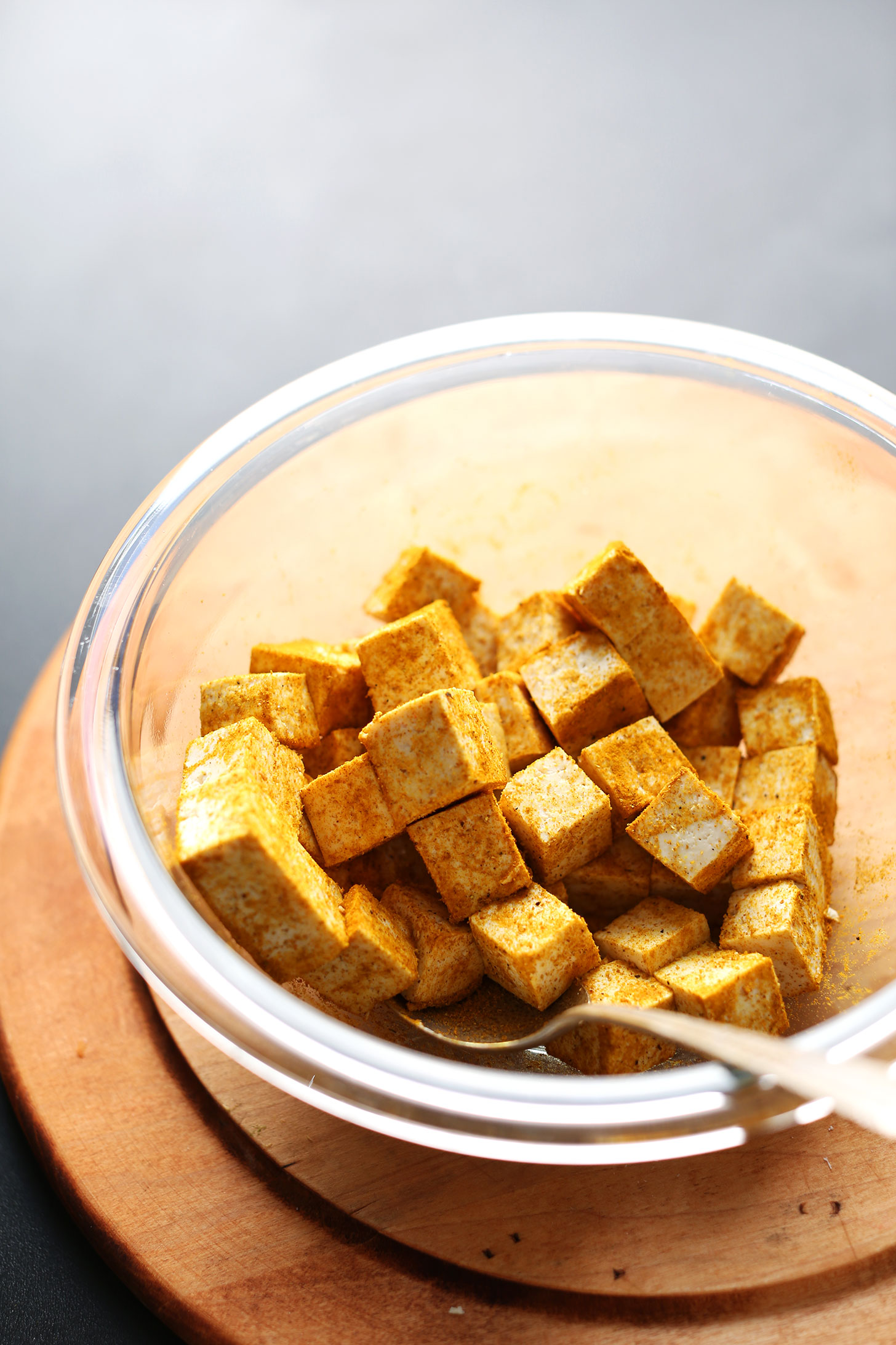 Stirring cubed tofu in spices for our Crispy Tofu recipe