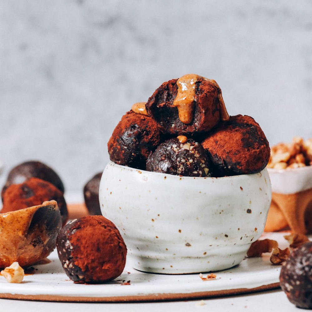 Bowl of No Bake Brownie Bites topped with almond butter