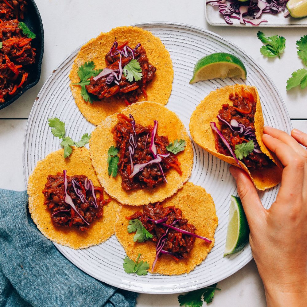 Picking up a taco from a plate