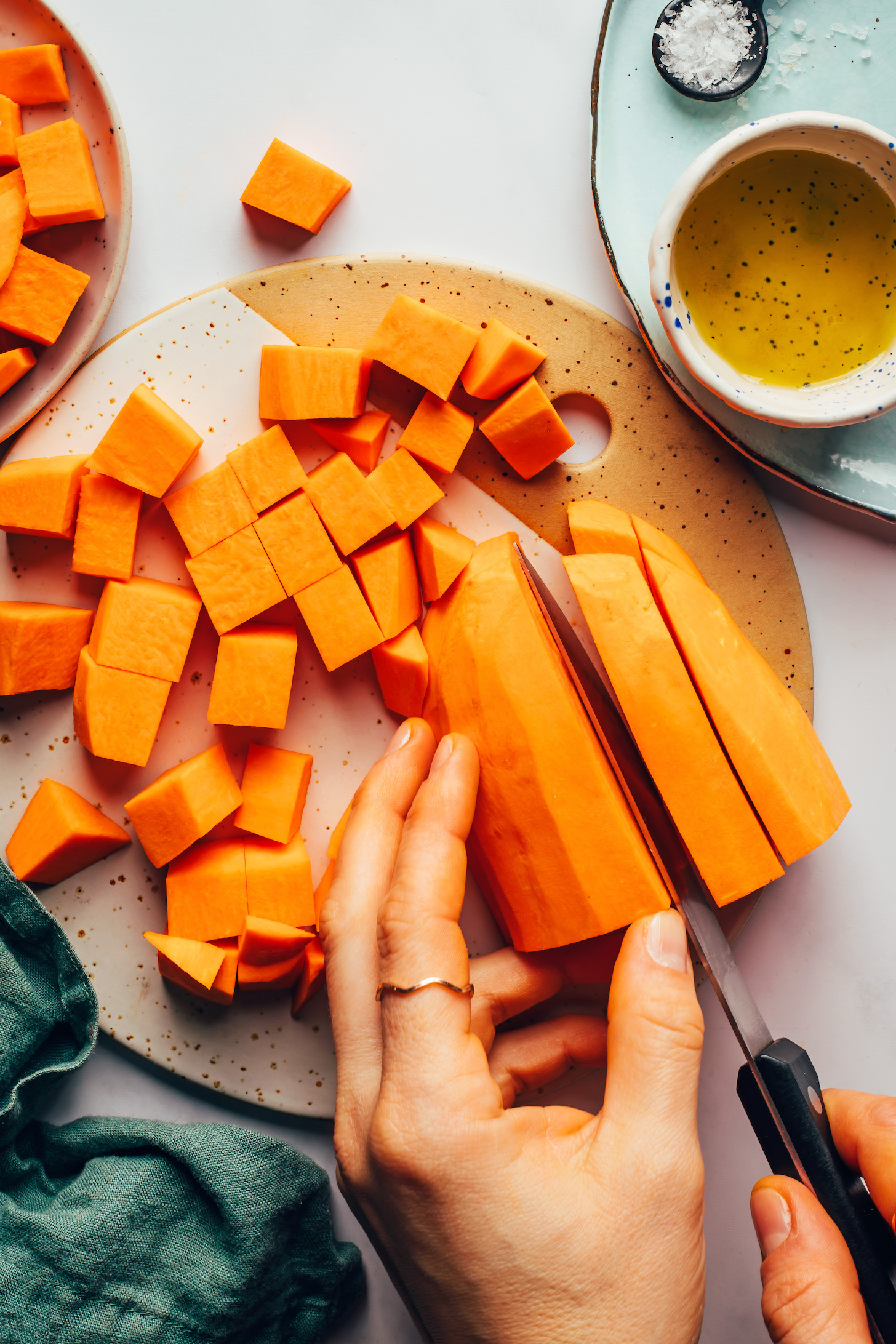 Chopping a sweet potato into cubes