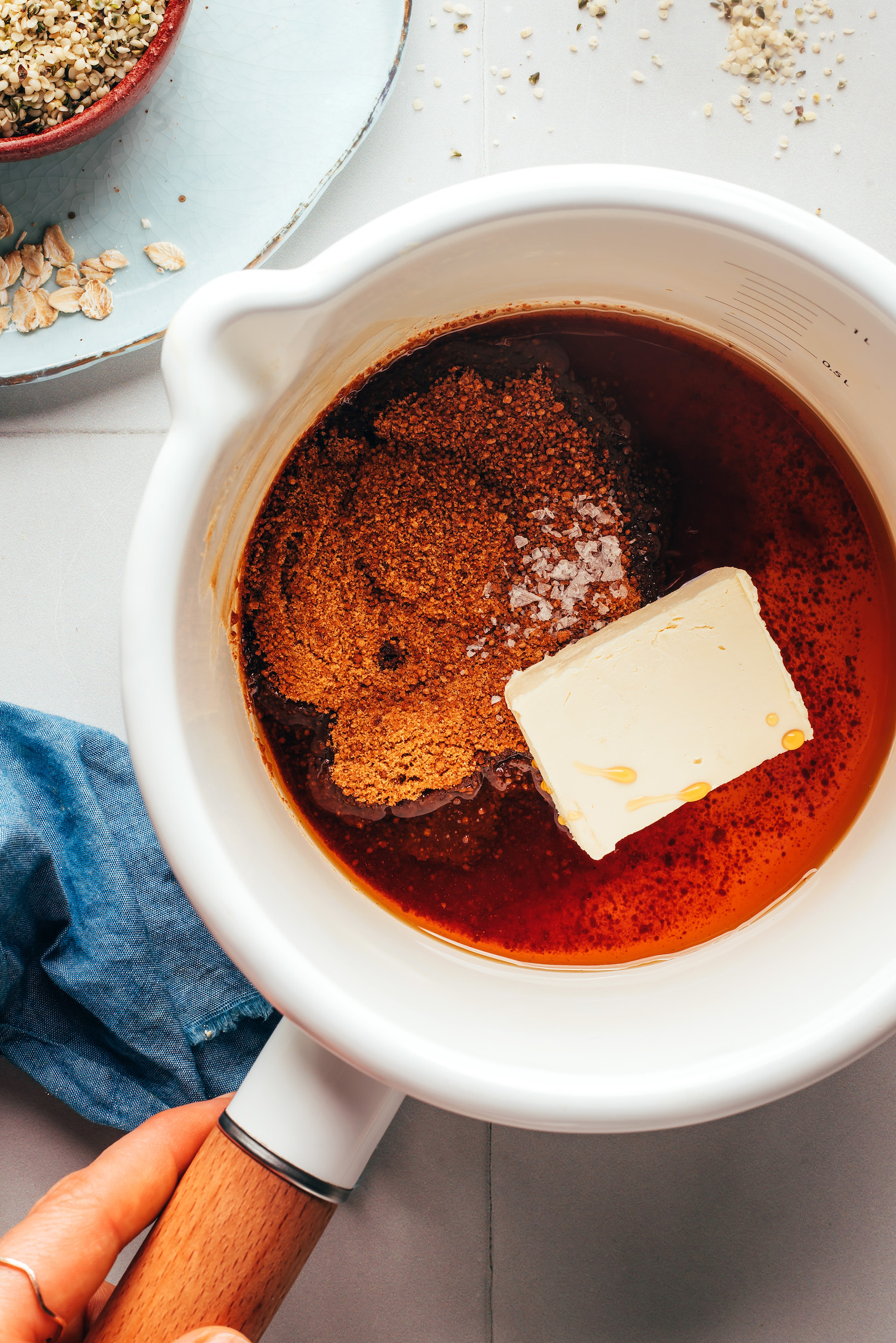 Saucepan with coconut sugar, maple syrup, vegan butter, vanilla, and sea salt