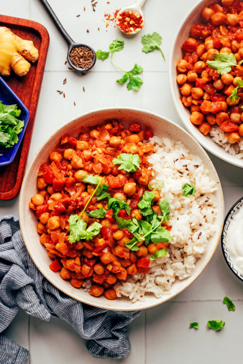 Vegan vindaloo-inspired chickpea curry in bowls with rice and cilantro