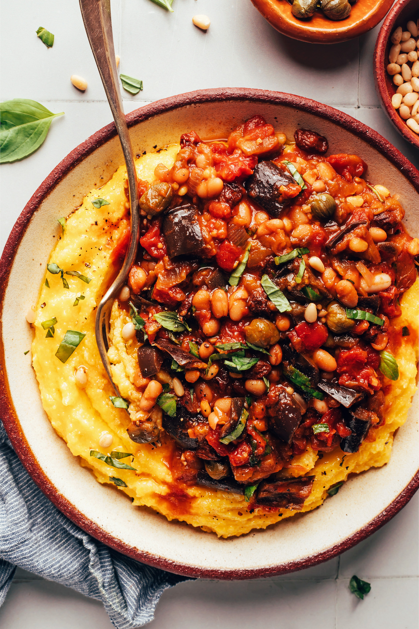 Serving of white bean eggplant caponata over polenta