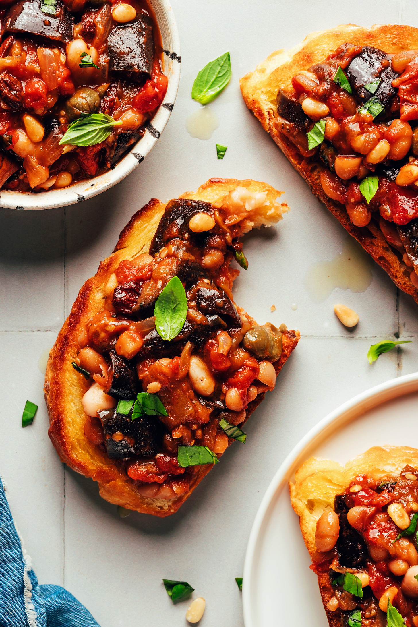 Slices of toasted bread topped with white bean eggplant caponata